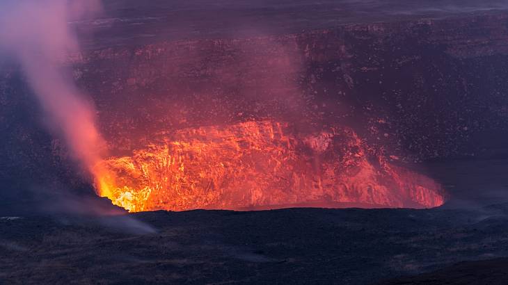 Steam and fire erupting from a volcano vent