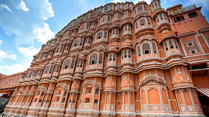 A unique exterior of a red and pink-coloured palace made of sandstone