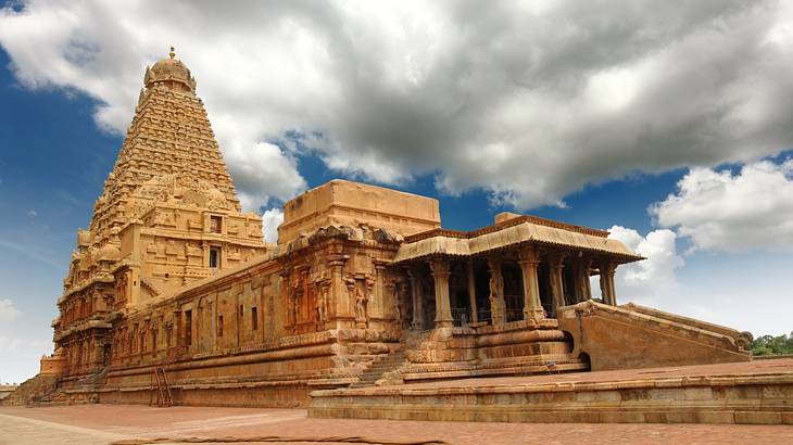 An ancient temple's magnificent structure against a cloudy sky