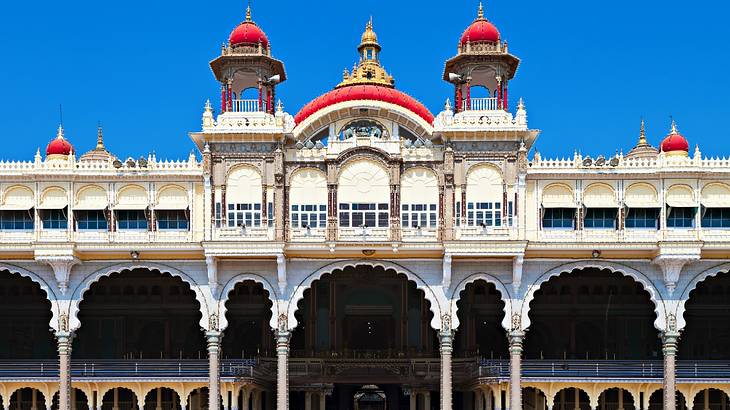 Front view of a palace with red tops against a blue sky