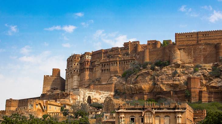 A massive fort palace on a hill in India on a beautiful clear blue day A massive fort palace on a hill in India on a beautiful clear blue day