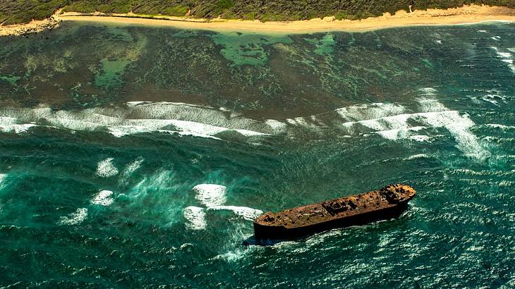 View from above of a shipwreck off a sandy coast