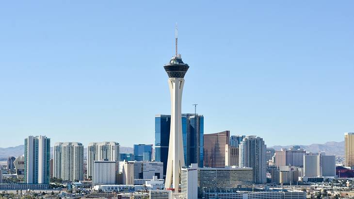 Daytime view of a skyline with an observation tower and tall buildings Daytime view of a skyline with an observation tower and tall buildings