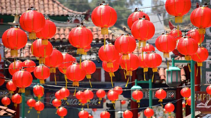 Up-close shot of Chinese red lanterns hanging over a street