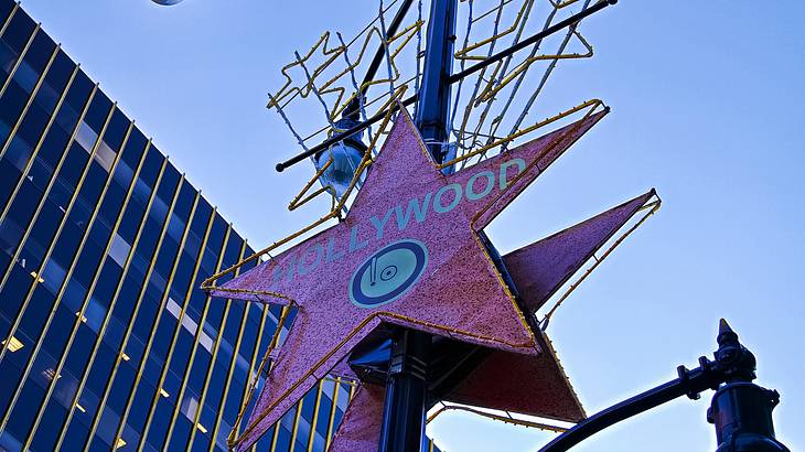 Hollywood Star signage on a street lamp post with a building behind