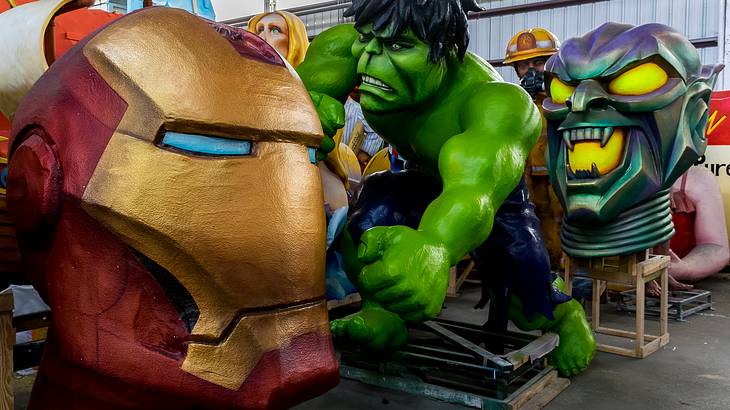 Life-size superhero replicas in a warehouse
