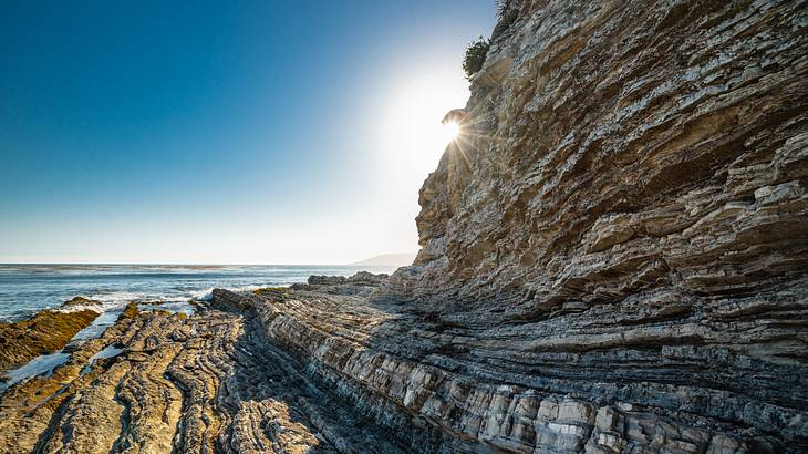 Rocky cliff near the ocean on a sunny day