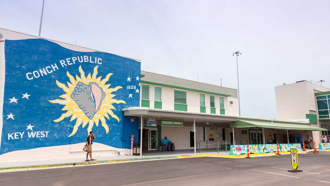 A building with a blue mural with a conch shell and Conch Republic written