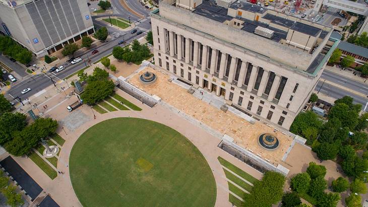 Aerial of a courthouse with a small public square and circle of grass in front of it