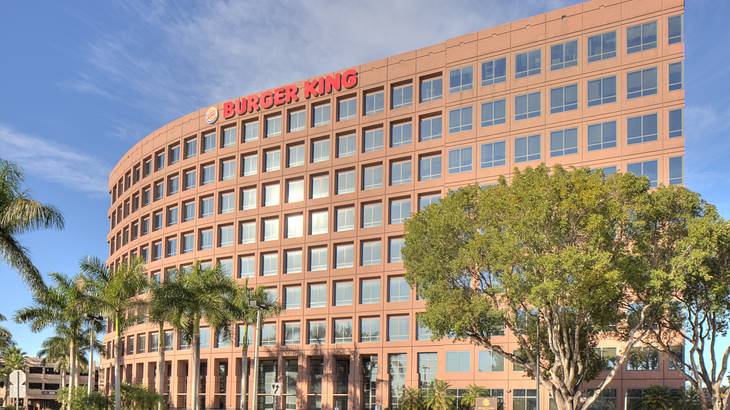 An office building with many windows and a Burger King sign on it