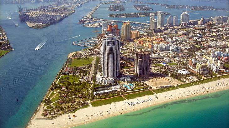 An aerial view of Miami with islands of beach and city surrounded by the ocean
