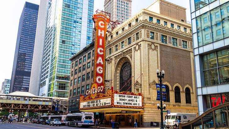 An old-fashioned building with illuminated "Chicago" sign, surrounded by skyscrapers