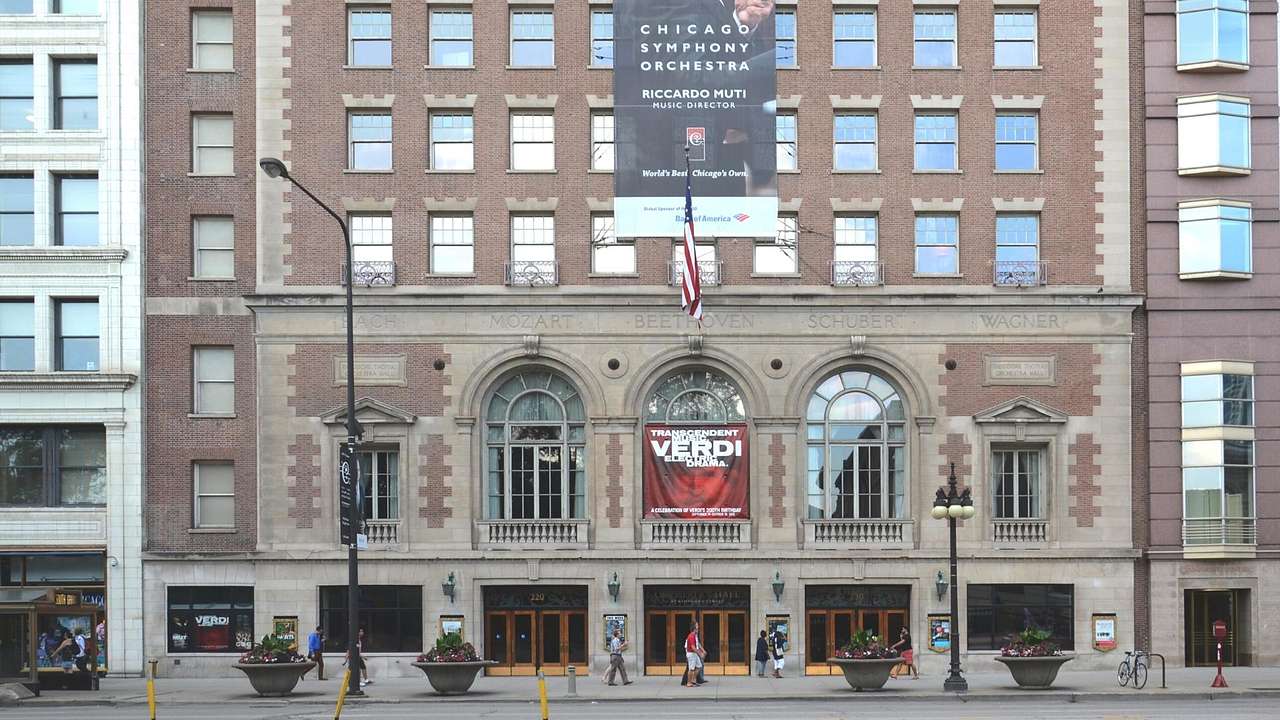 A red-brick building with many windows and a Chicago Symphony Orchestra banner on it
