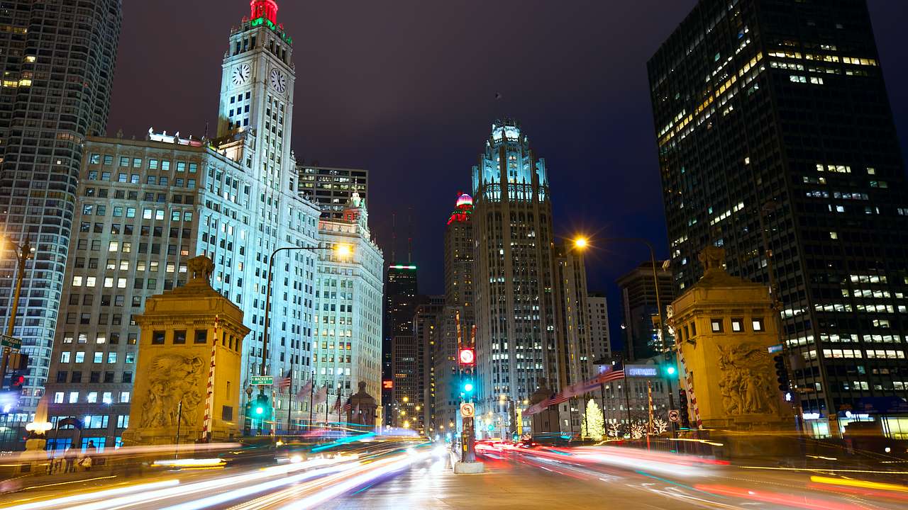 A road in a city at night with lit-up skyscrapers on either side