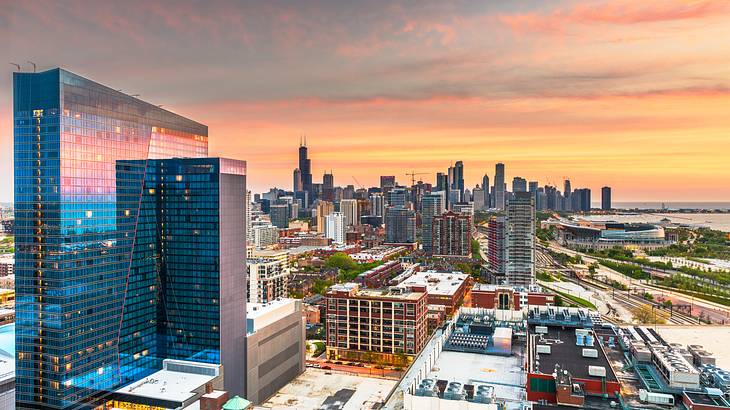 The view across a city with lots of buildings at sunset