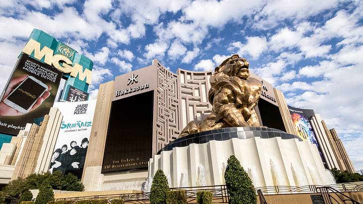 A hotel with MGM sign and a gold lion statue in front of it