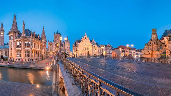 Panoramic view of a bridge over a canal and adjacent buildings at dusk