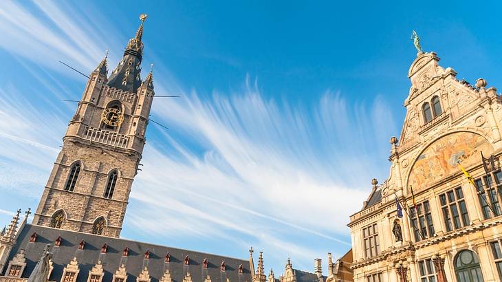 Looking up at two medieval towers during daytime