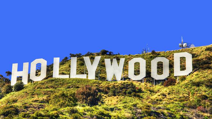 White-letter signs spelling out Hollywood on a green hill on a clear day