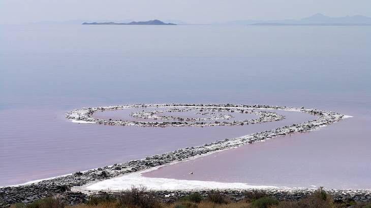 A spiral earthwork in a lake with mysterious pink water