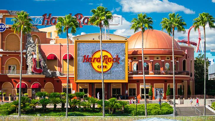 Iconic "Hard Rock Cafe" signage on a dome-shaped building by a garden