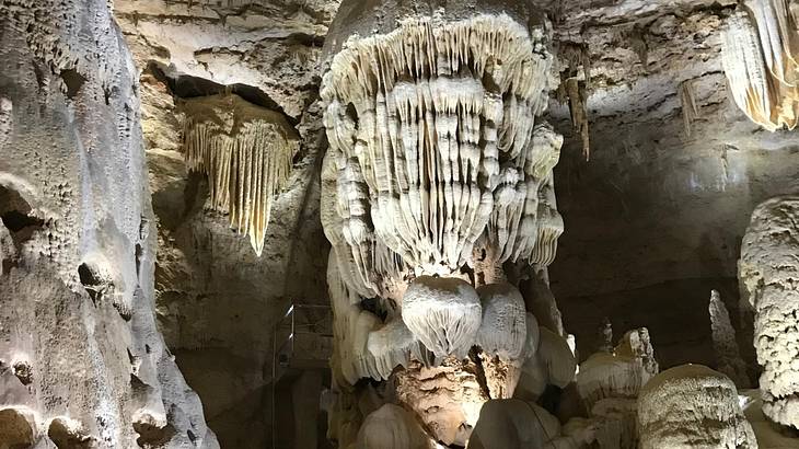 Limestone rocks and structures hanging from the ceiling of a cave