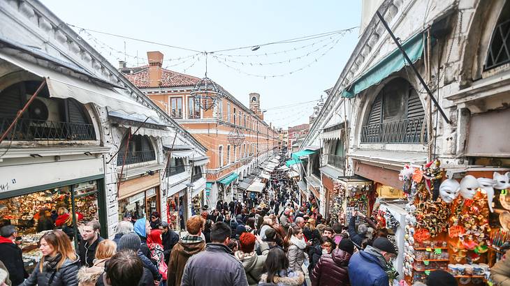 Crowded passage with various shops selling colorful souvenirs