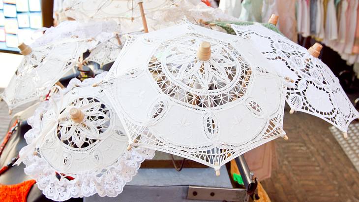 Looking down on white lace umbrellas displayed in a shop