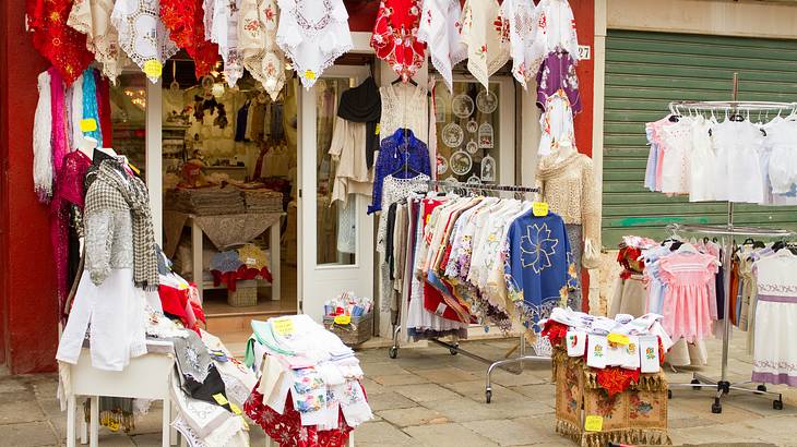 Local shop selling colorful lace handicrafts and clothing on racks