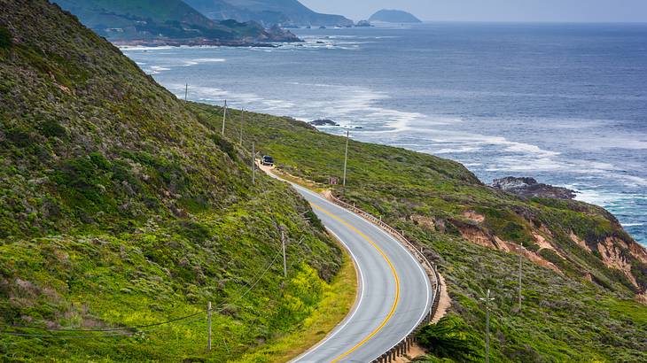 On one side, a mountain with a roadway overlooks a beach