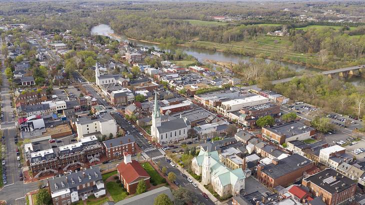Aerial view of a town with historic buildings and a nearby river with trees