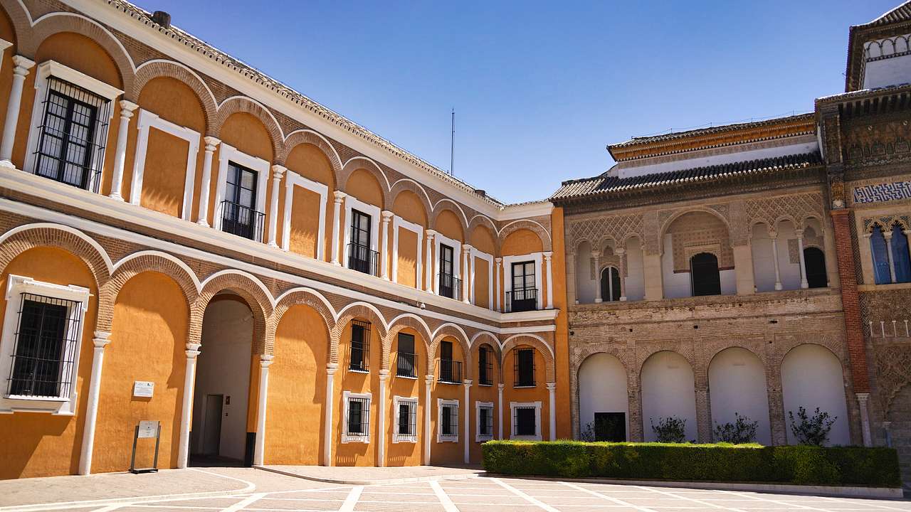 An interior courtyard with a long yellow rectangular building on the left