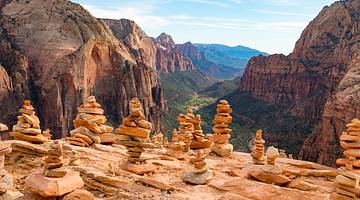 Human-made rock piles in front of a valley with mountains on either side