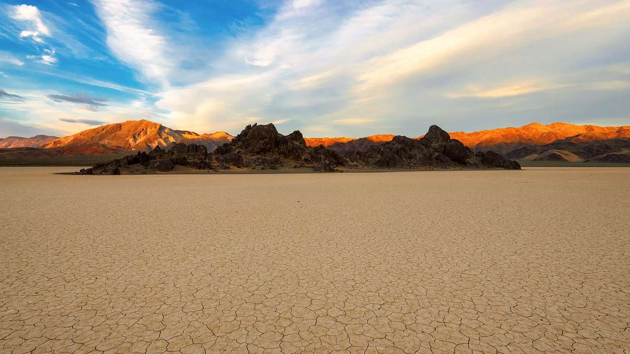 Dry desert plain with mountains in the background with almost no vegetation