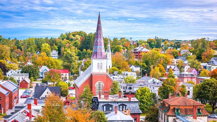 Colorful foliage, a church with a tall spire, and buildings from above
